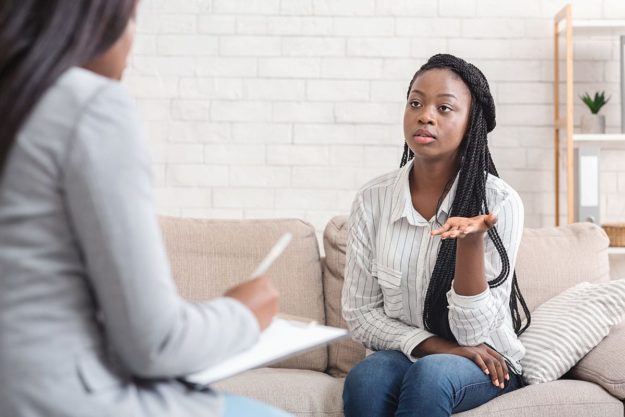 4 woman speaks with cognitive behavioral therapy professional