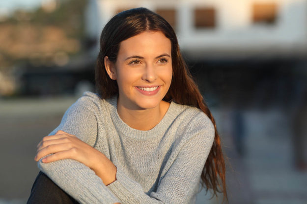 woman smiling outside having overcome substance abuse