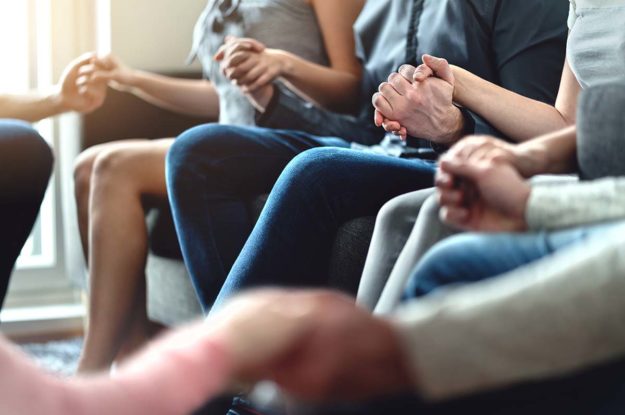 Benefits of Peer Support Amid Mental Health Struggles a group displays peer support for mental health