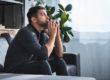person on couch dealing with anxiety triggers